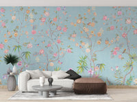 Living area featuring a light blue floral wall mural with a brown chaise living room.