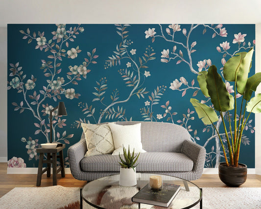Blue chinoiserie wall mural with delicate white blossoms and winding silver branches.