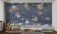 Cute blue mural with space animals floating joyfully for kids room.