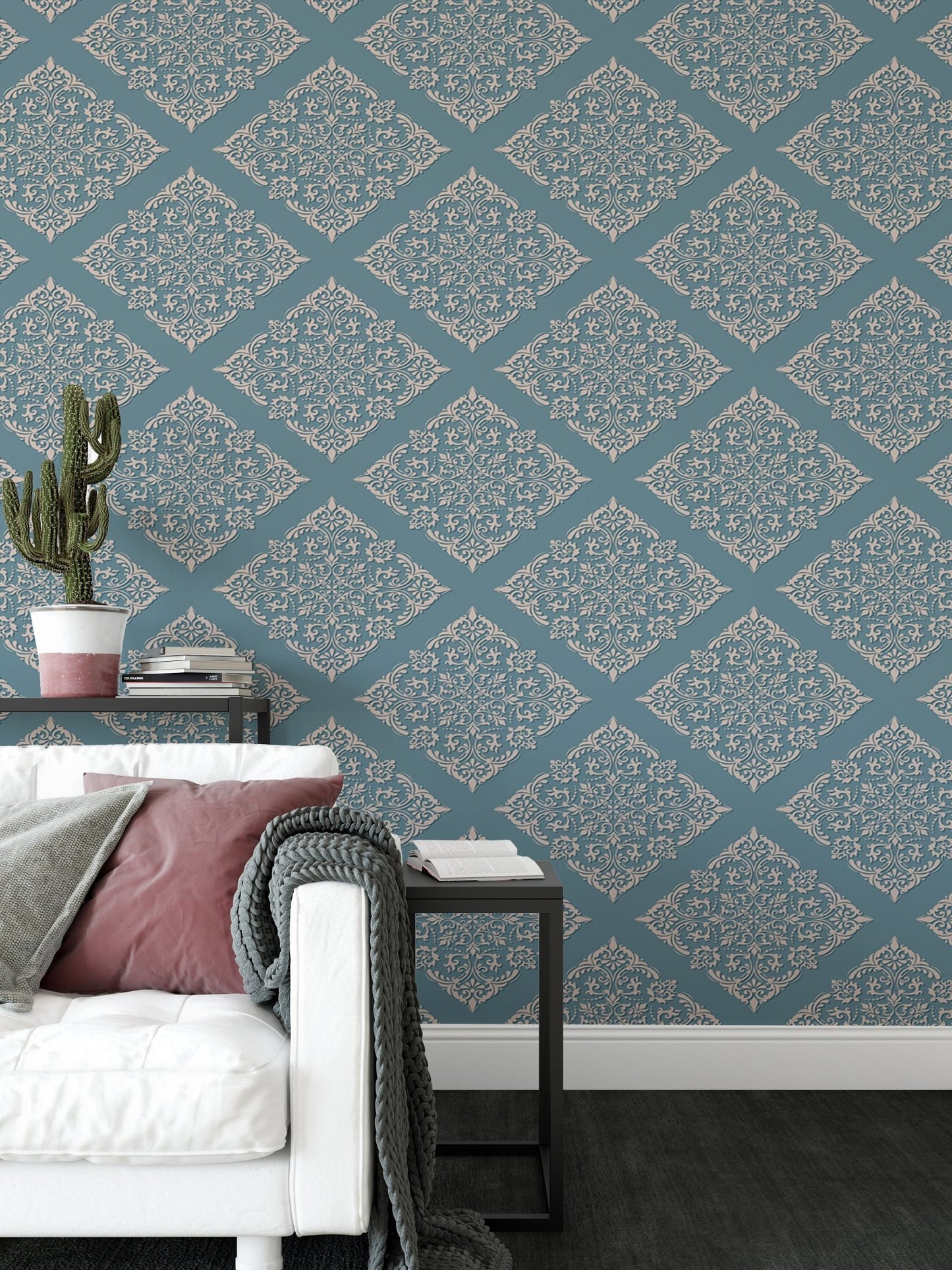 Patterned blue wallpaper in living area behind white sofa with cushions.