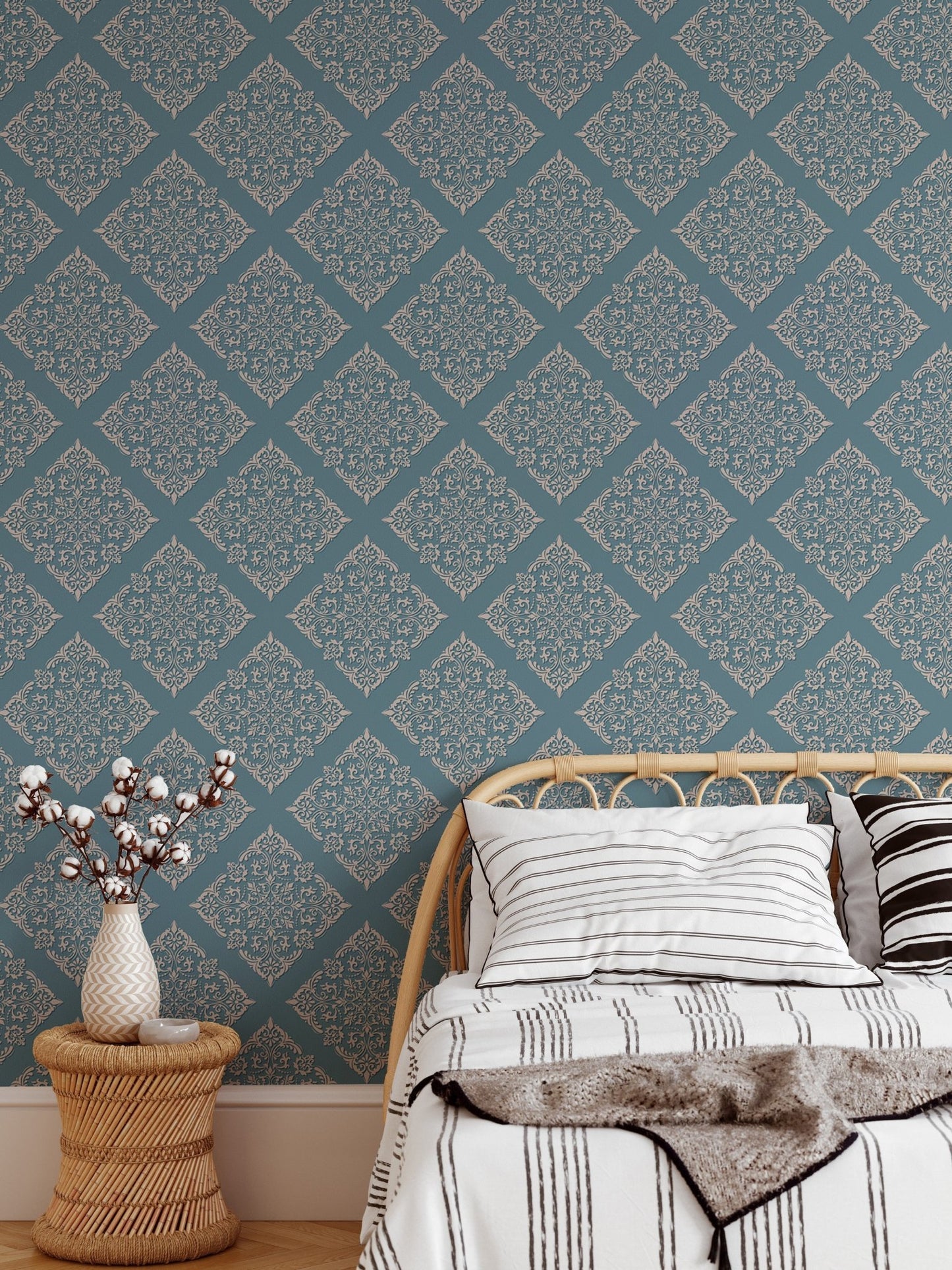 Modern damask wallpaper in bedroom behind white bedding and bed.