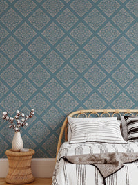 Modern damask wallpaper in bedroom behind white bedding and bed.