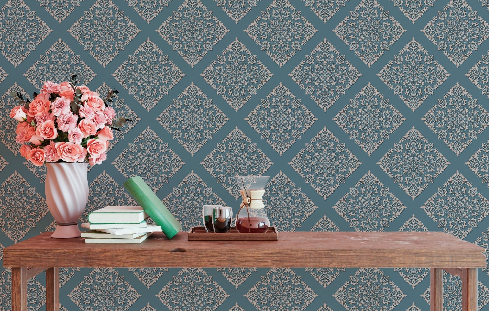 Blue patterned wallpaper in study area behind wooden table with flowers.