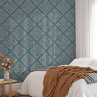 Modern damask wallpaper in master bedroom with brown throw blanket.