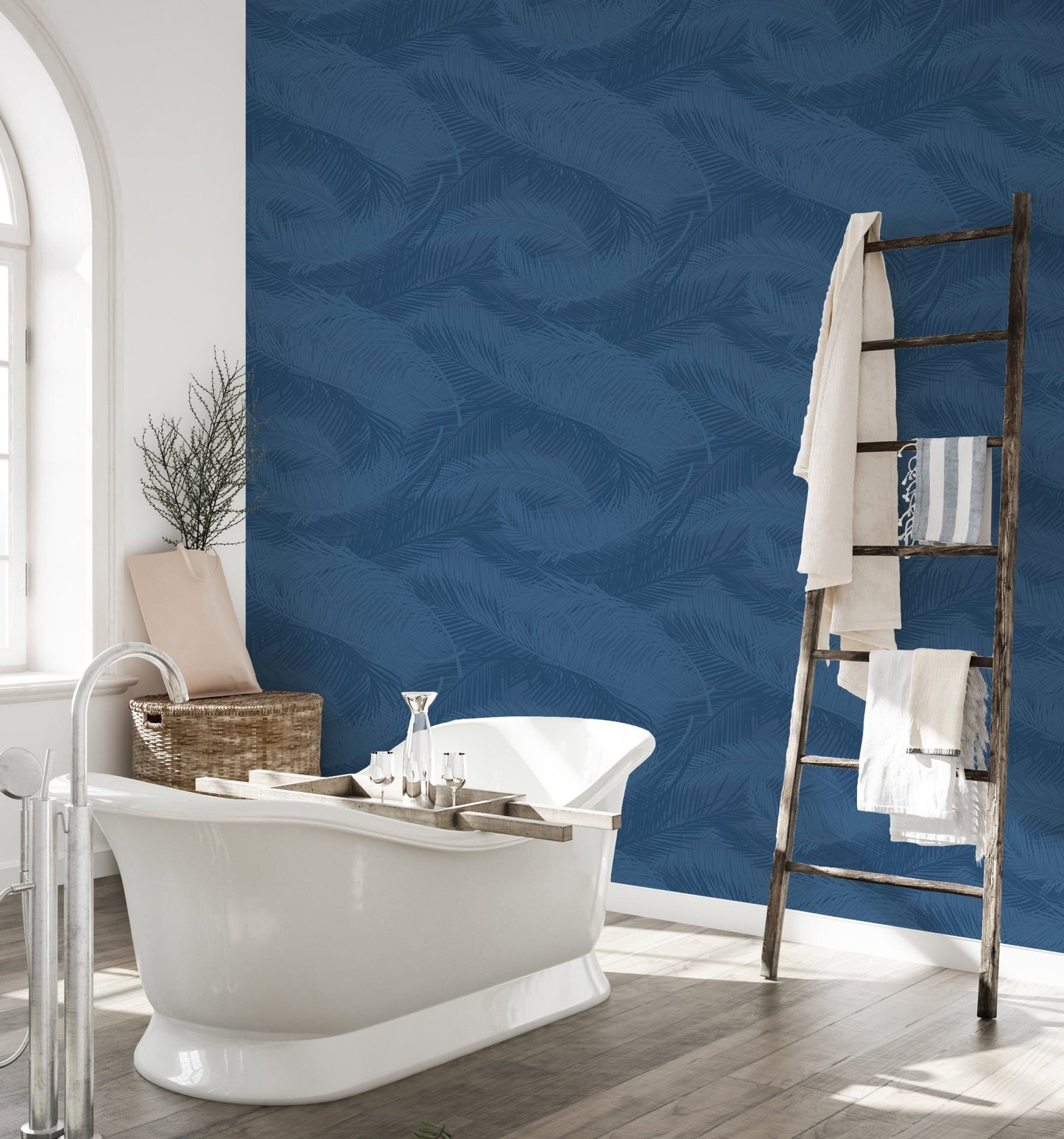 Waterproof blue leaf wallpaper in a bathroom with white freestanding tub.