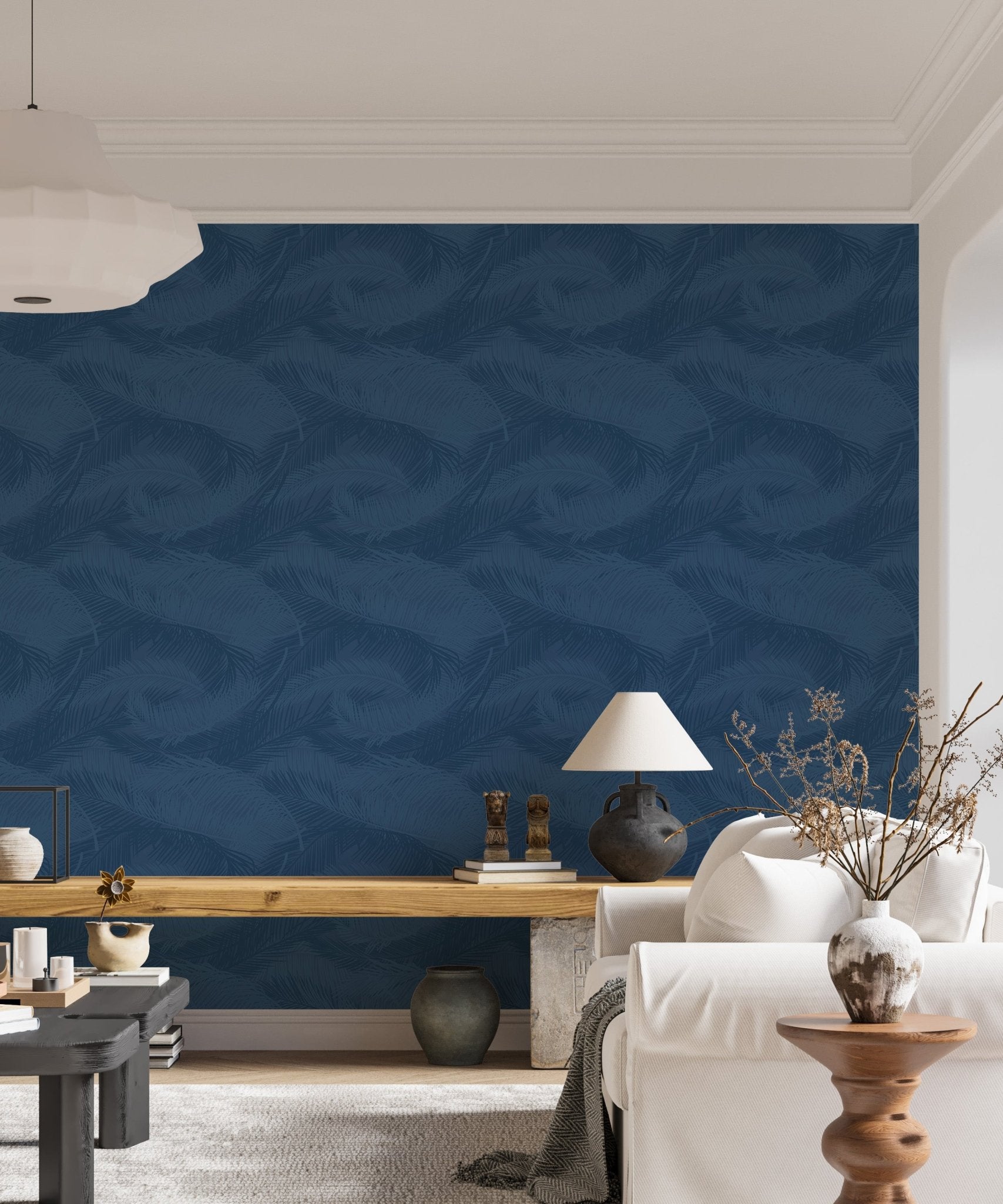Blue palm foliage wallpaper in a living room behind a white media console.