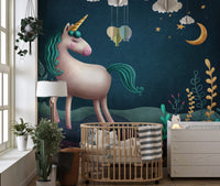 Dark navy night sky unicorn wall mural beside a baby crib in toddler room.
