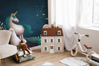 3D unicorn wall mural next to a white dollhouse and toy bike in a play area