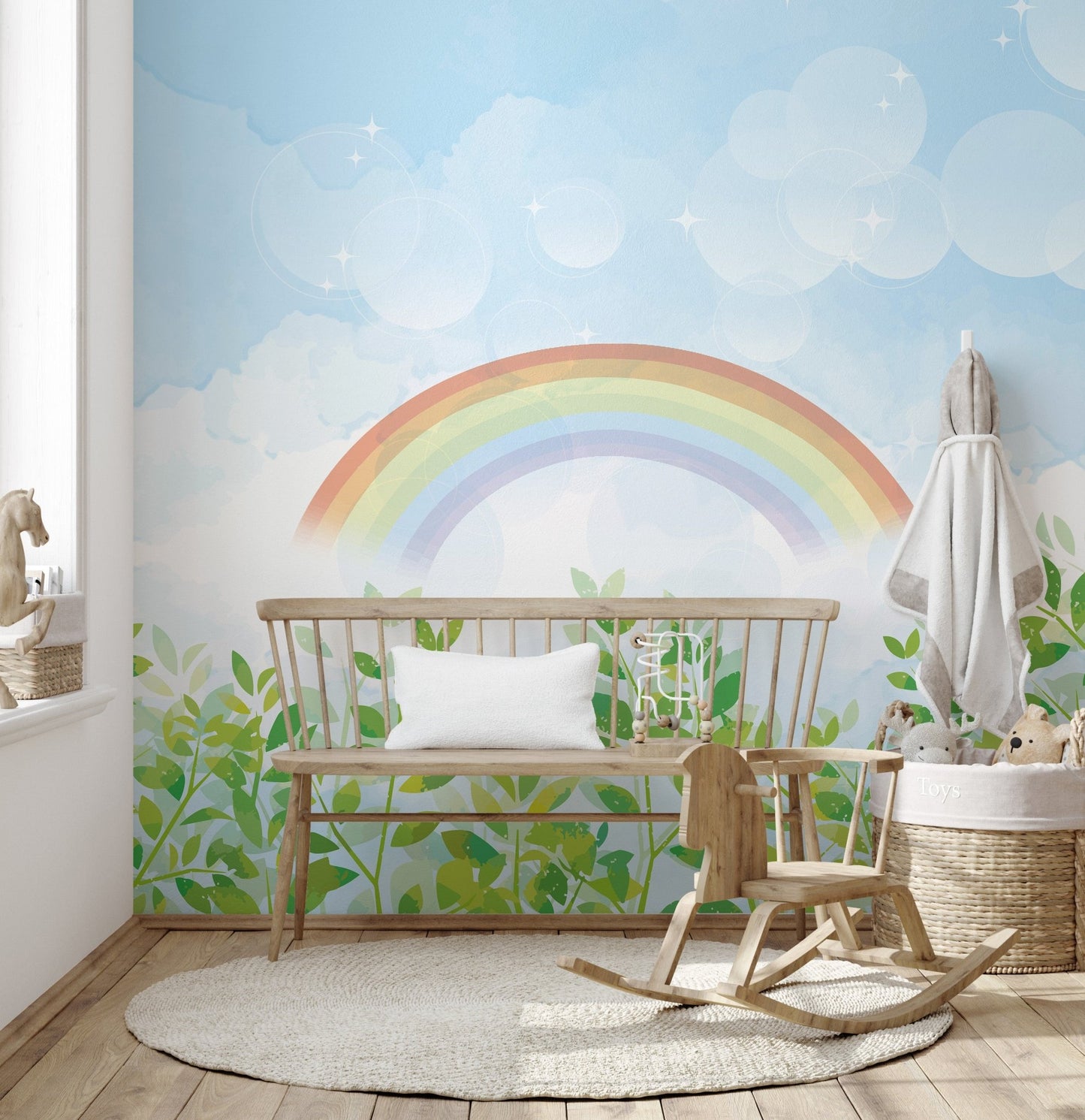 Gentle blue-green rainbow wall mural in minimalist nursery.
