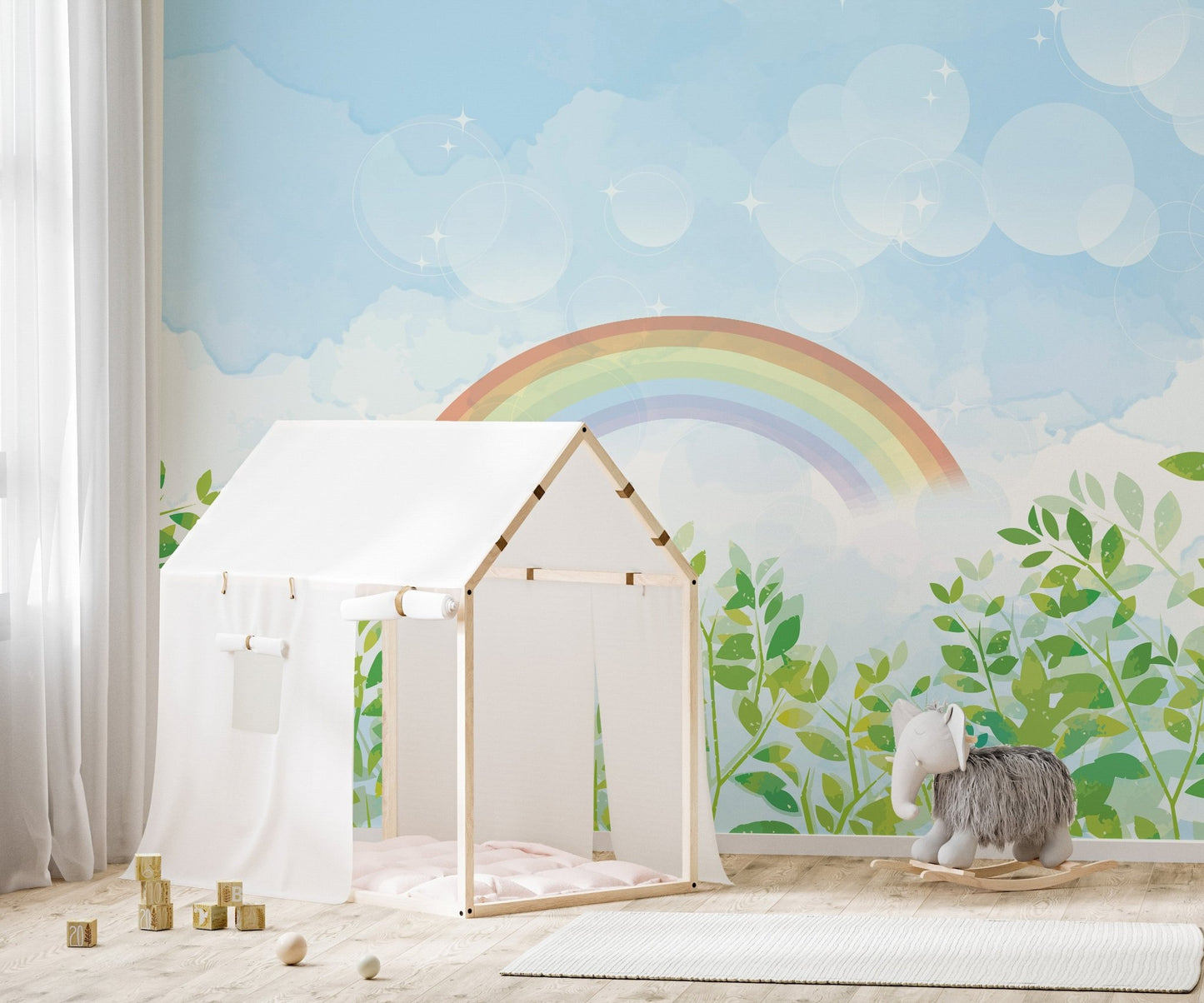 Soft watercolor rainbow mural in bright nursery area.
