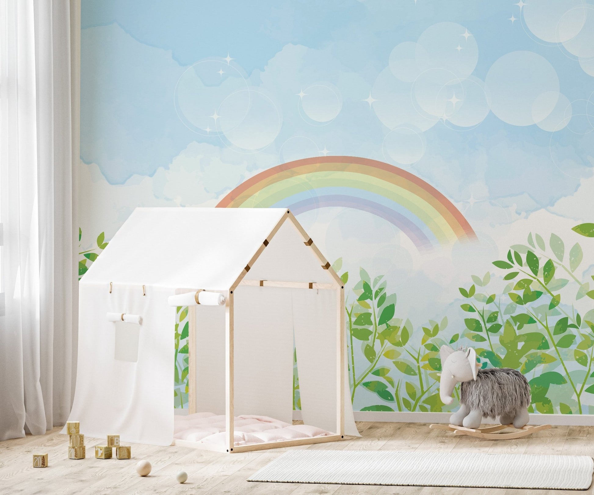 Soft watercolor rainbow mural in bright nursery area.
