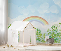 Soft watercolor rainbow mural in bright nursery area.
