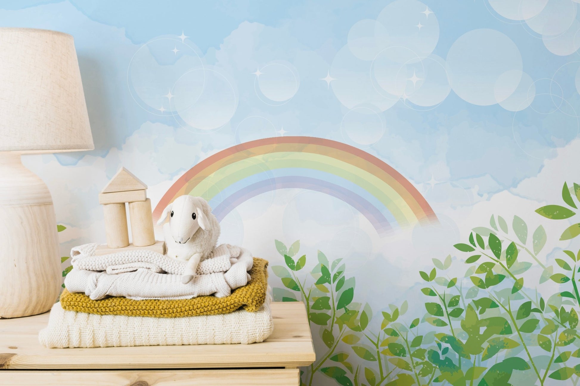 Kids bedroom featuring a pastel rainbow wall mural with green leaves.