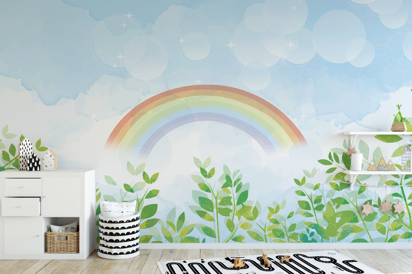 Playroom decorated with a watercolor rainbow and sky wall mural.