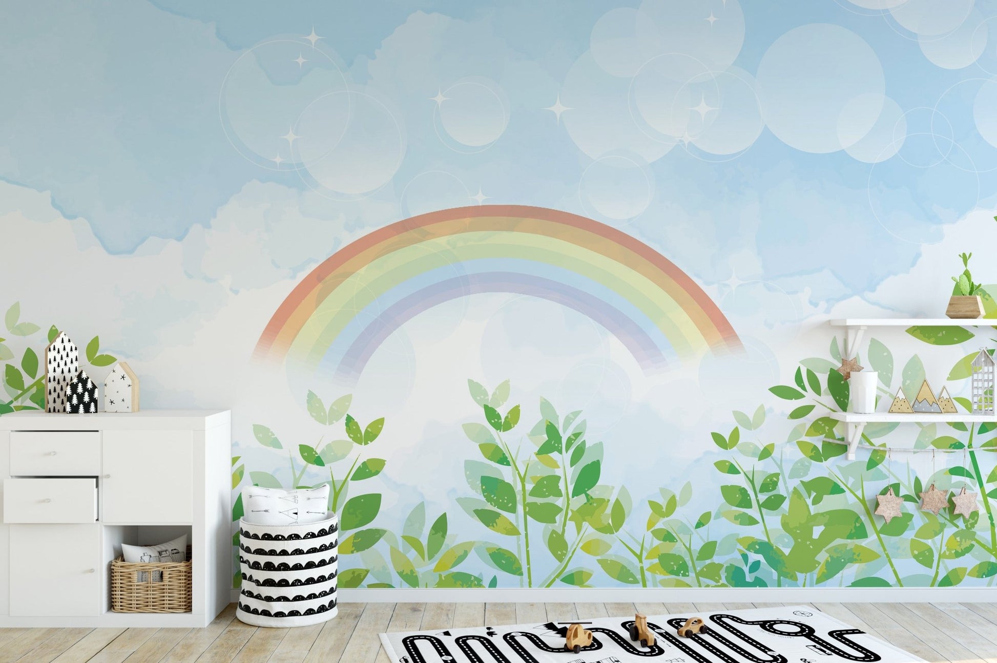 Playroom decorated with a watercolor rainbow and sky wall mural.