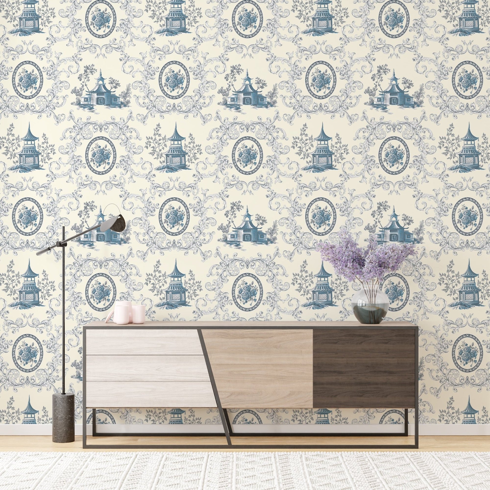 Blue Rose Flower House and Baroque Swirls Toile Wallpaper behind a modern sideboard.