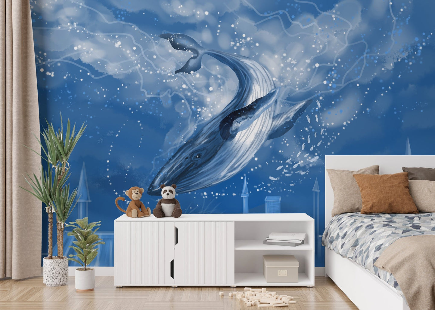 Ocean themed whale wall mural in a bedroom with soft floor cushions.