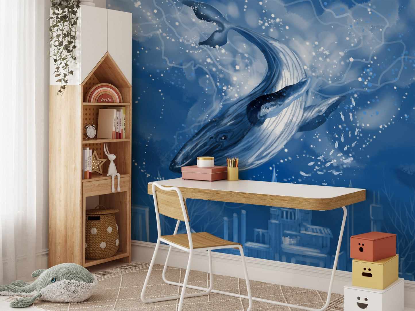 Artistic whale wallpaper mural in a home study with a wooden desk.