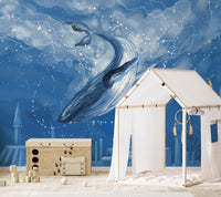 Blue aquatic wall mural behind a white dresser in a modern nursery.
