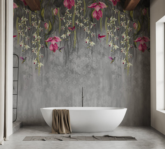 Pink hanging blossom wall mural behind white bathtub in luxury bathroom.