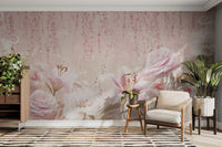 Sitting area with a beige armchair against a soft pink rose wall mural.