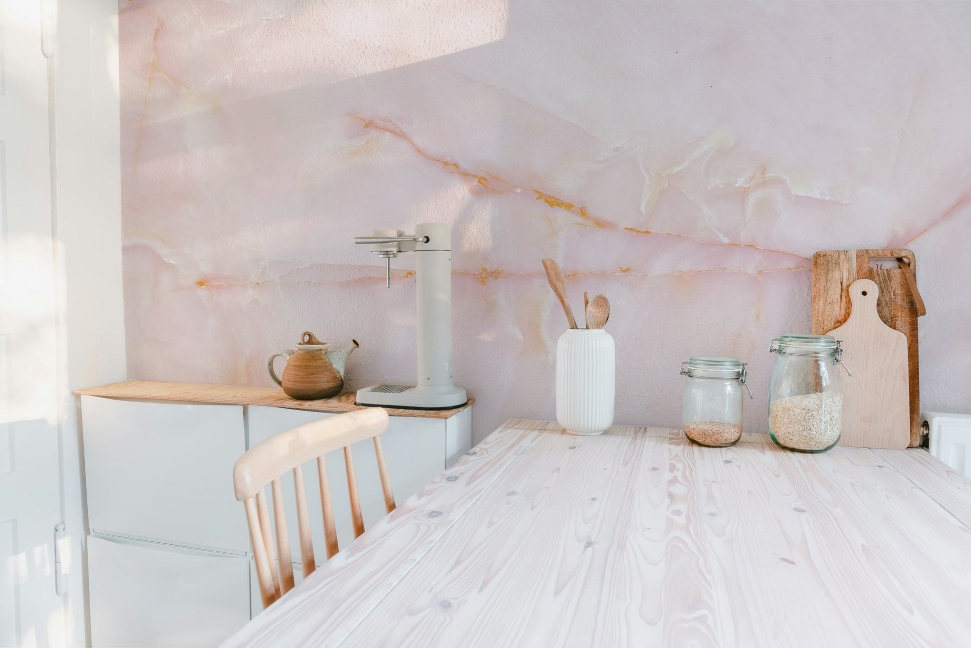 Pink onyx marble wall mural with intricate and soft designs in kitchen.
