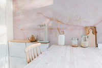 Pink onyx marble wall mural with intricate and soft designs in kitchen.