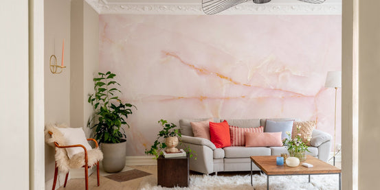 Blushing pink marble mural adding warmth and sophistication to living room walls.
