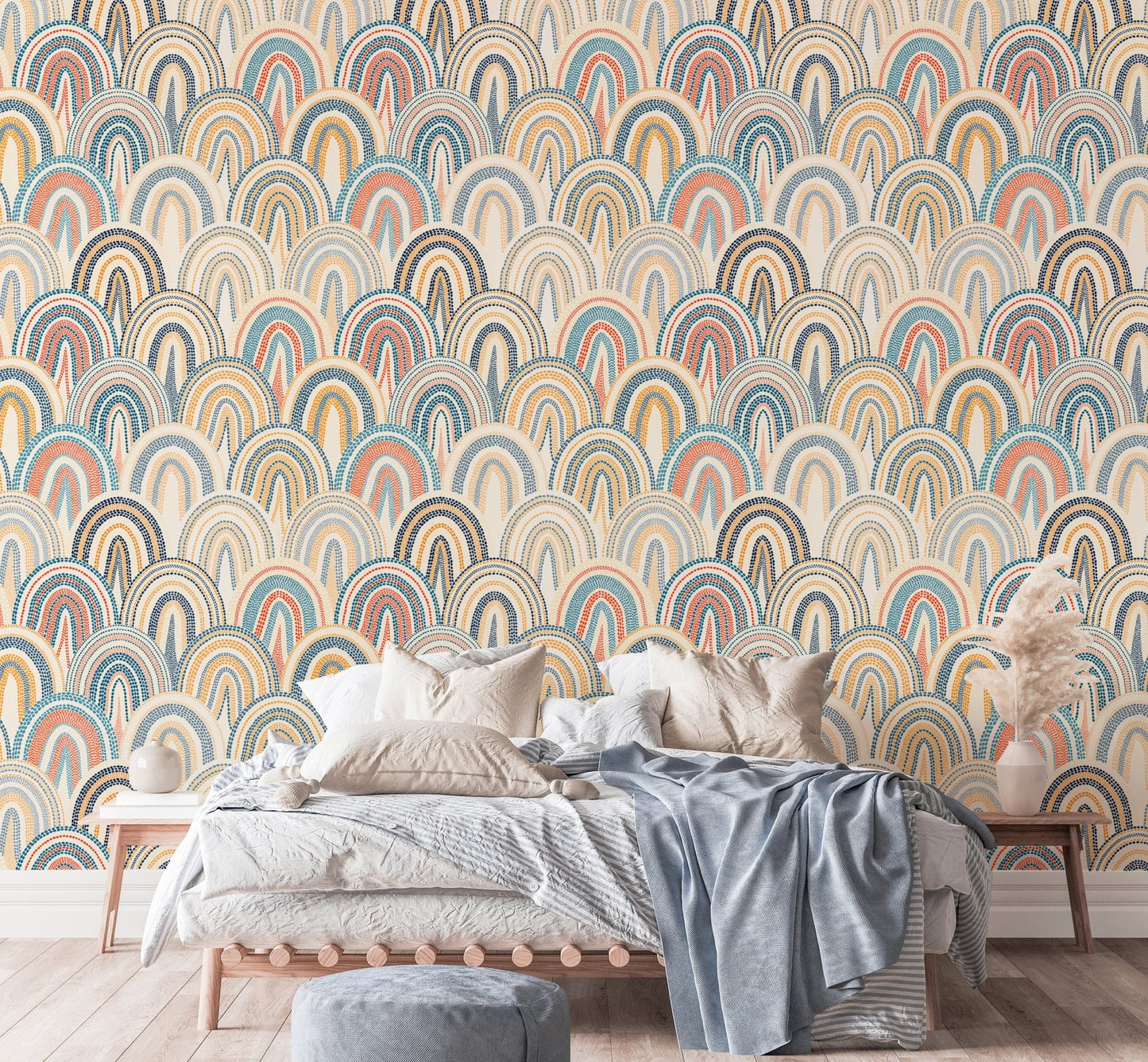 Retro arch pattern wallpaper behind a bed with grey and blue linens.