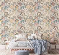 Retro arch pattern wallpaper behind a bed with grey and blue linens.