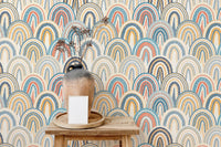 Multi-color scallop pattern wallpaper behind a wooden console table.