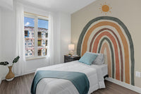 Colorful boho rainbow mural for a playful bedroom design.
