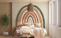 Soft boho rainbow mural creating a cozy bedroom atmosphere.
