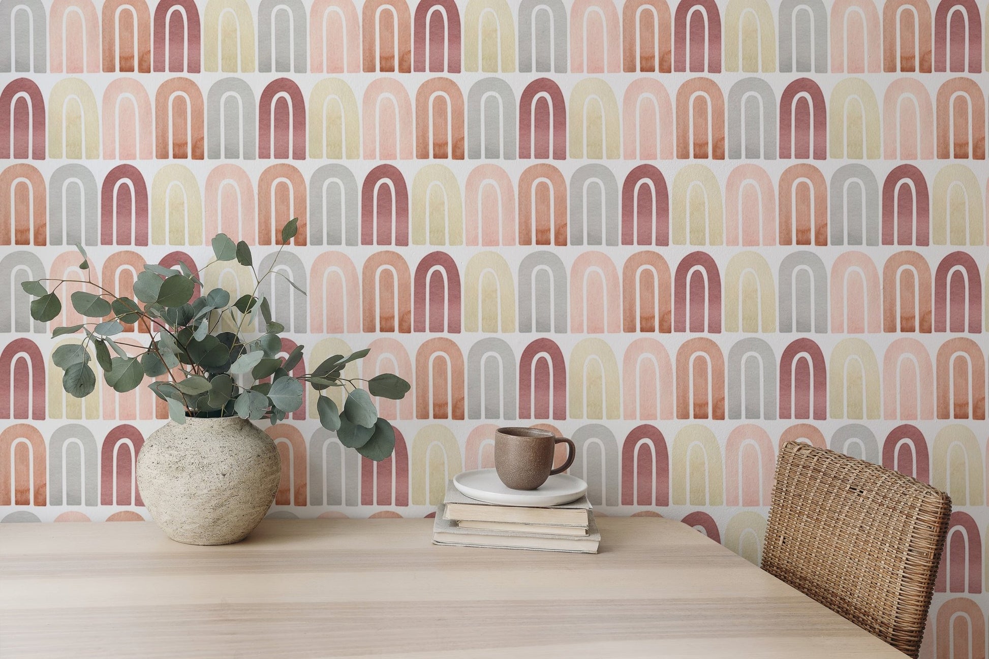 Peel and stick watercolor wallpaper in pastel tones behind wooden dining table.