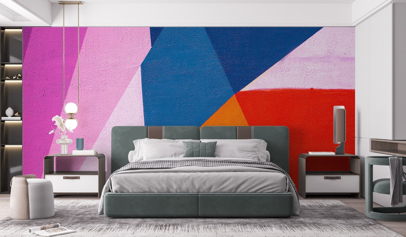 Bold abstract triangle wall mural with pink and blue geometric color blocks.