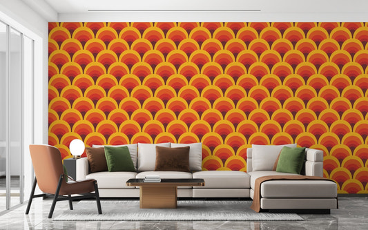 Retro geometric pattern wallpaper behind a contemporary grey sofa in a bright living room.