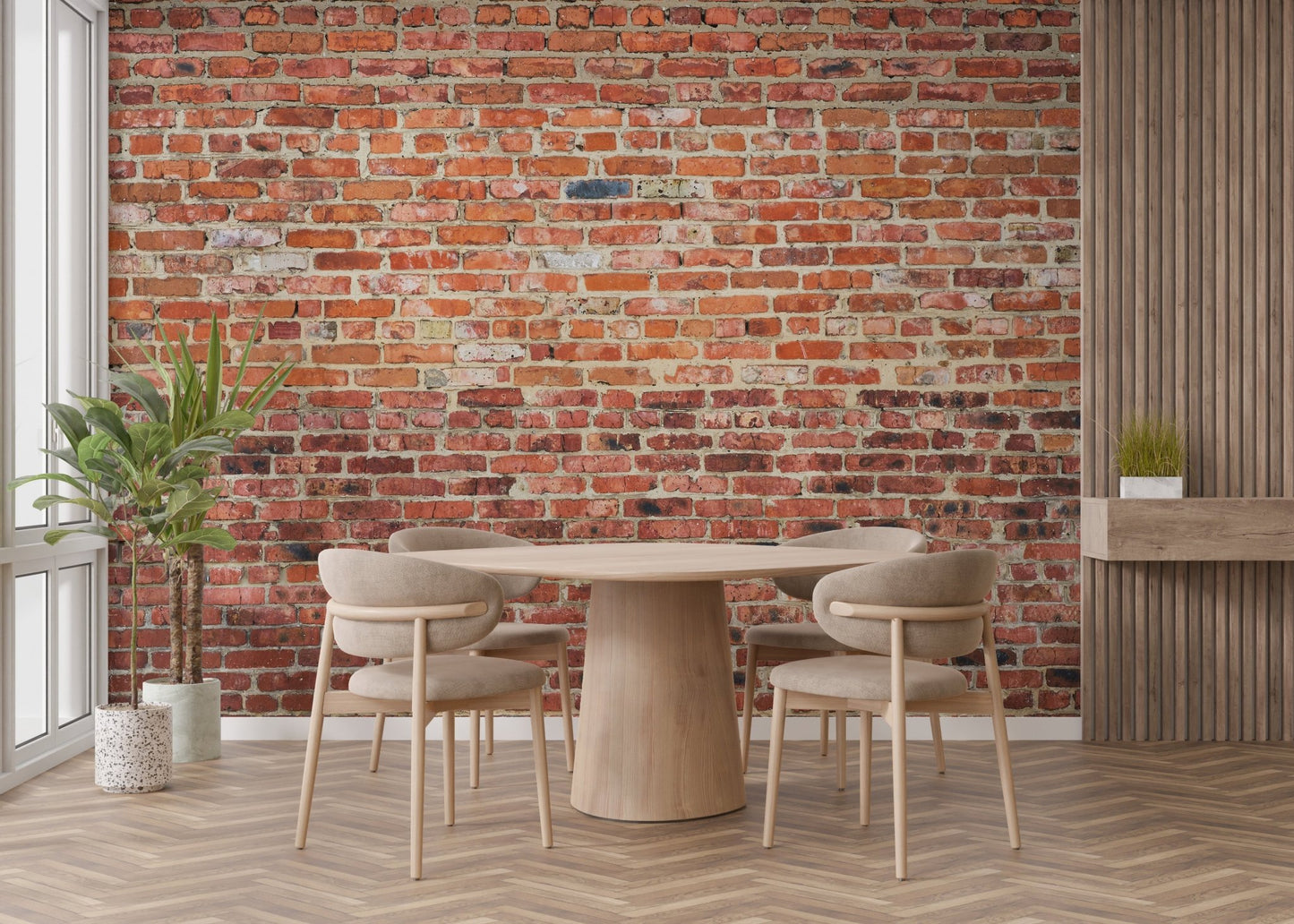 Minimalist dining space with a round table and red brick wall mural.