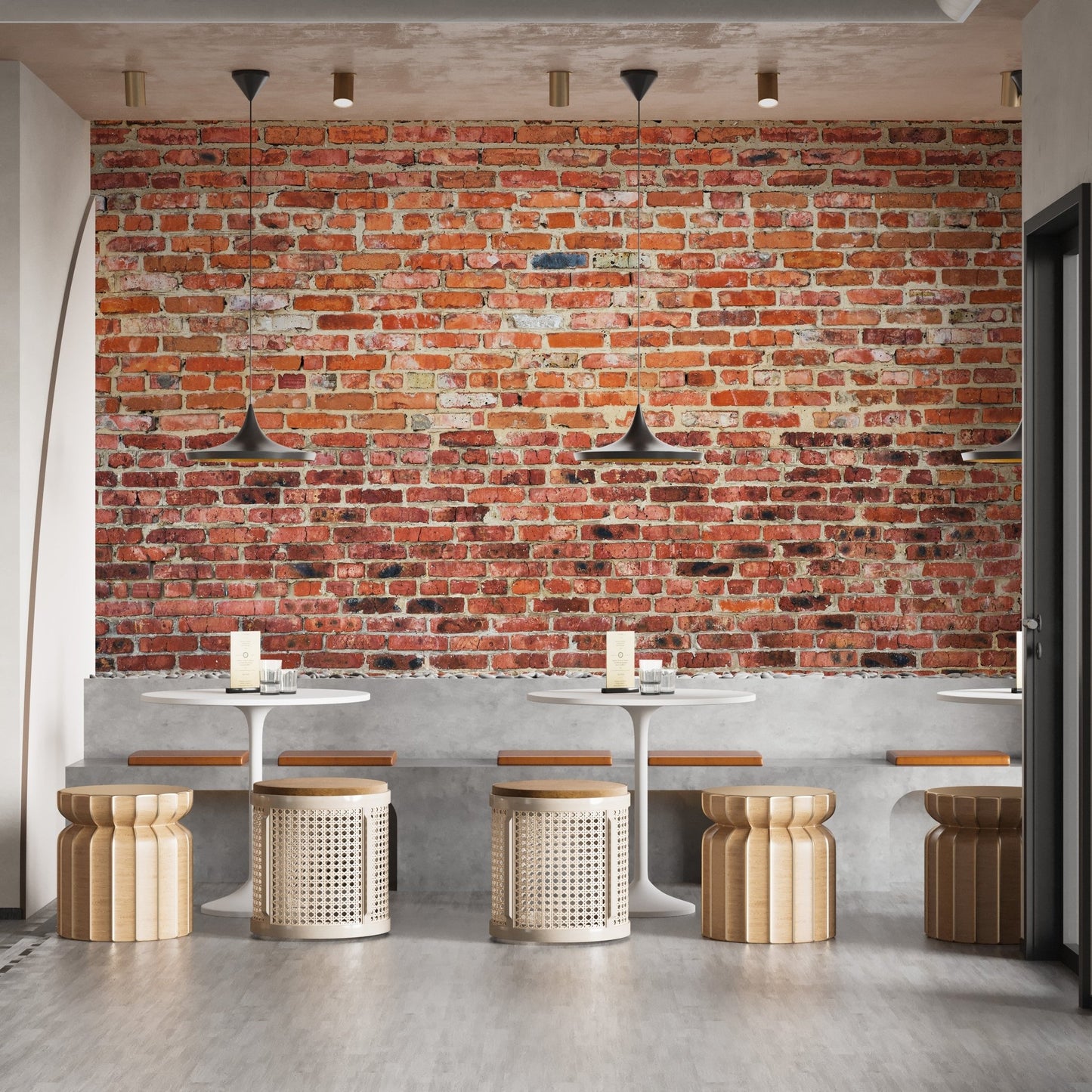 Coffee house seating area with vintage brick wall mural and pendant lights.