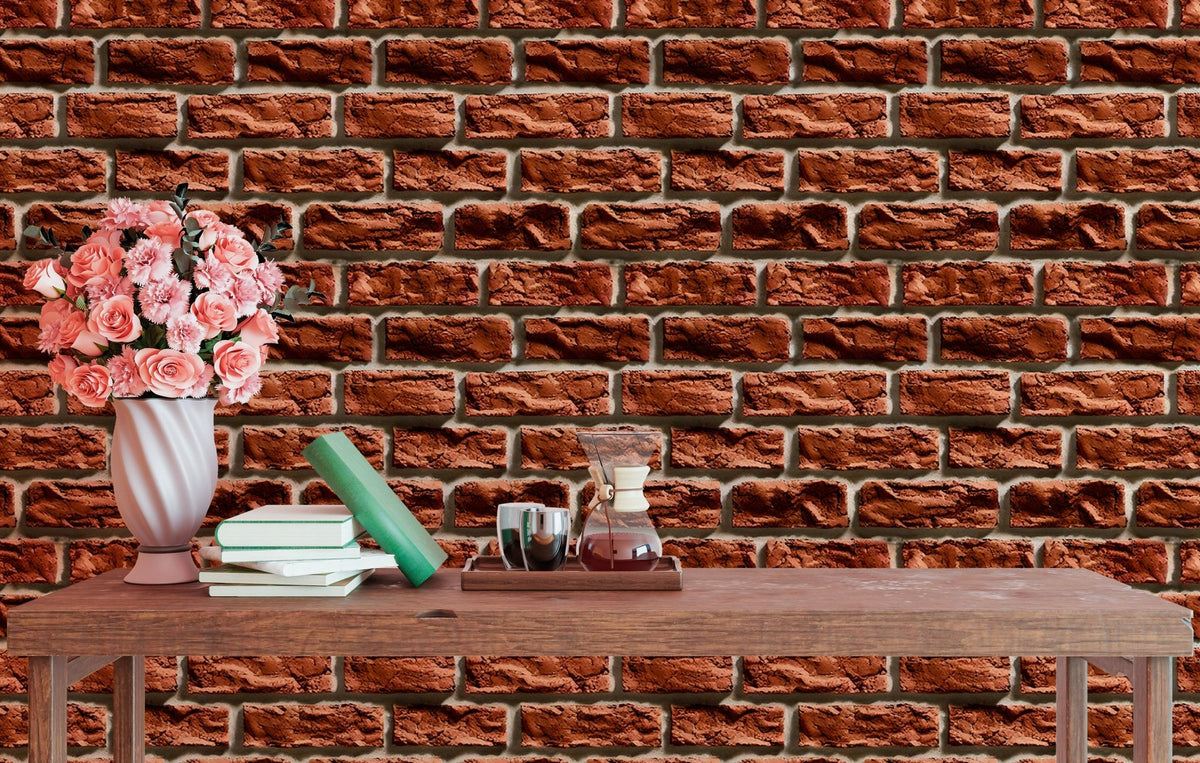 Textured brick wallpaper in a dining area with pink flowers on a wooden table.