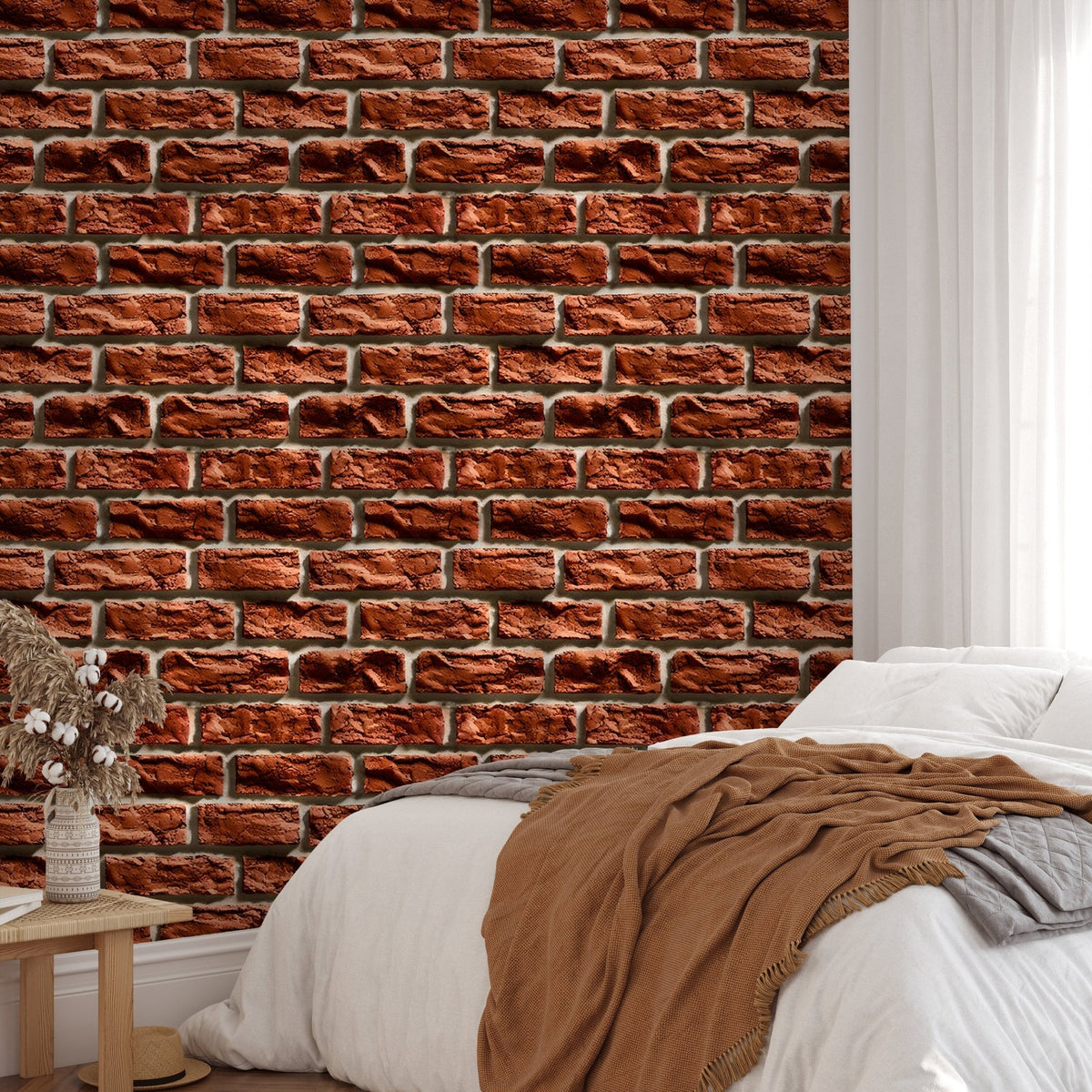 Rustic brick wallpaper in a bedroom with white linens and a brown throw blanket.