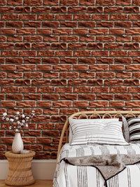 Realistic brown bricks wallpaper in a bedroom featuring a minimalist wooden bedside table.