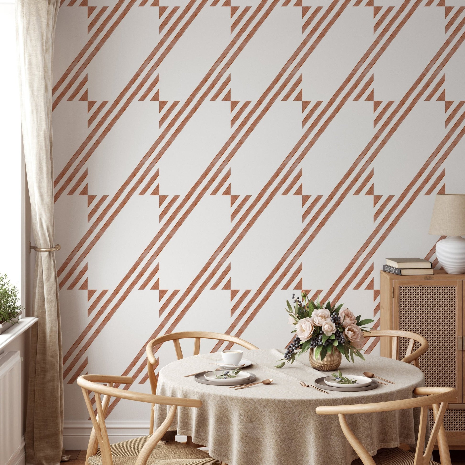 Dining room featuring brown diagonal stripe wallpaper and circular wooden table.