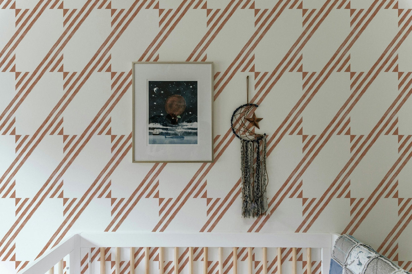 Wallpaper with terra cotta geometric stripe behind a framed art piece.