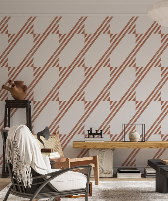 Minimalist living area with brown geometric wallpaper and a leather chair.