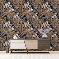 Tropical dry leaves wallpaper behind a modern wooden sideboard cabinet.