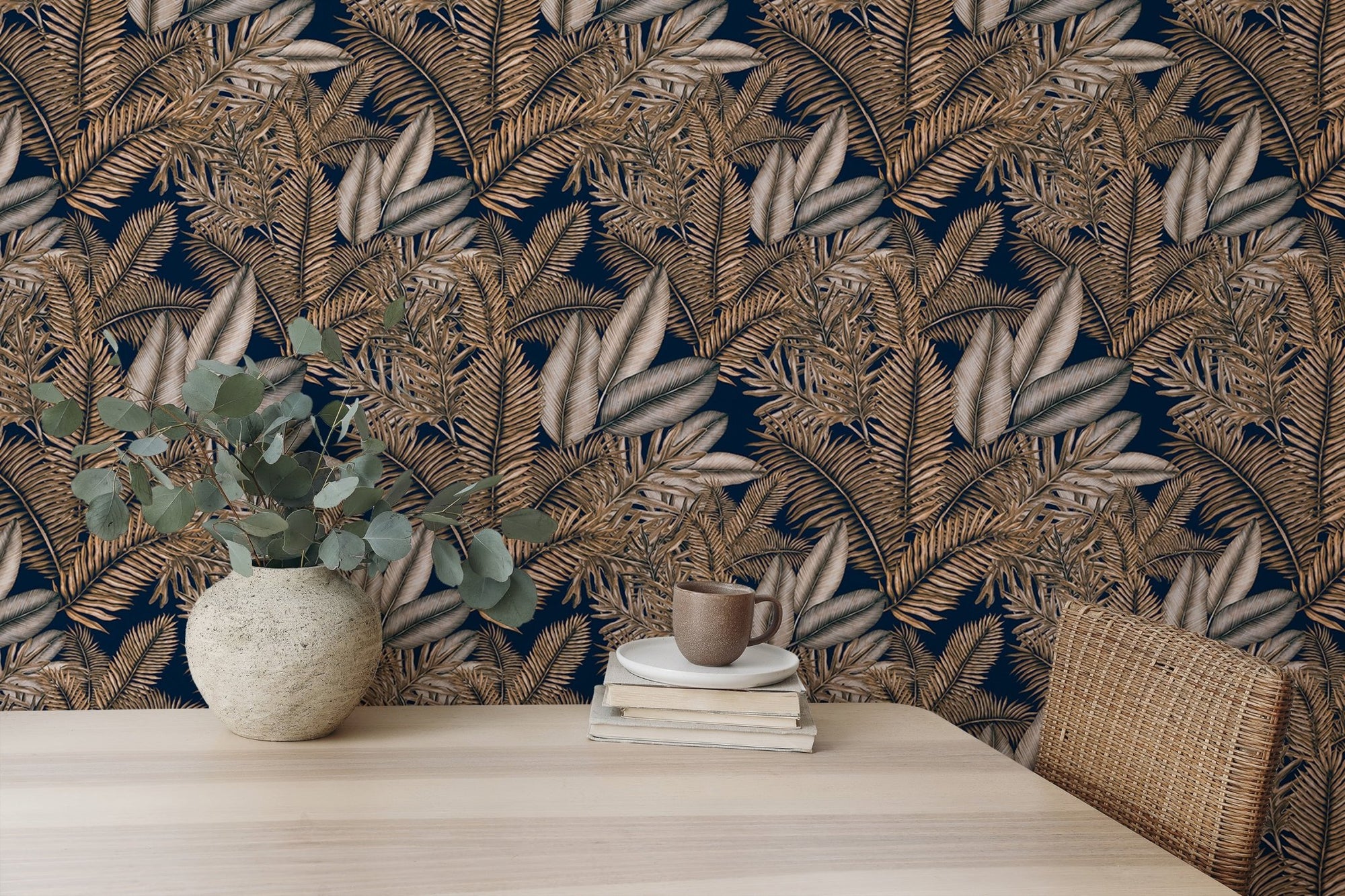 Brown color seamless pattern tropical dry leaves wallpaper behind a wooden table.