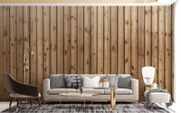 Brown vertical plank wall mural in a living room with a grey sofa and rug.