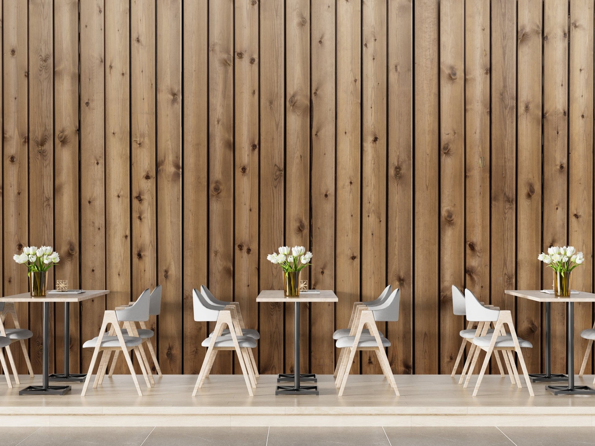 Narrow wood strip wall mural behind small cafe tables and white chairs.