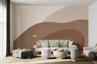 Beige wall mural with wavy brown abstract shapes in seating space
