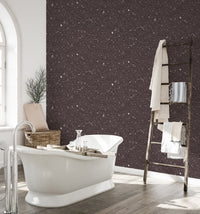 Dark brown quartz wallpaper in a bathroom with a white freestanding bathtub.